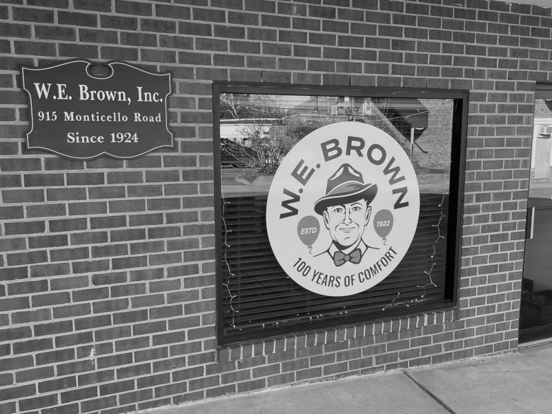 Black and white photo of front-window featuring anniversary logo